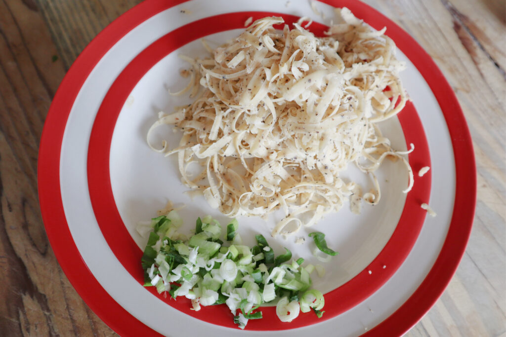 grated cheese and chopped spring onions